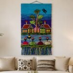 Colorful handwoven village wall hanging with red rooftop cottages and figures