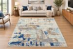 Blue and beige abstract area rug styled in a modern living room