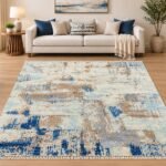 Blue and beige abstract area rug styled in a modern living room